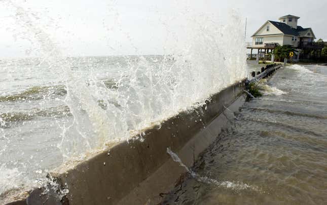 Water from Galveston Bay crashes over a barrier September 12, 2008 in Seabrook, Texas, ahead of Hurricane Ike.