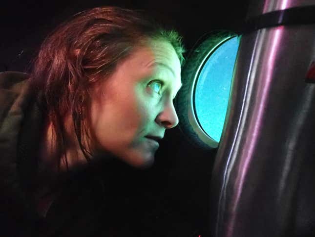 Photo of person looking out of submarine window